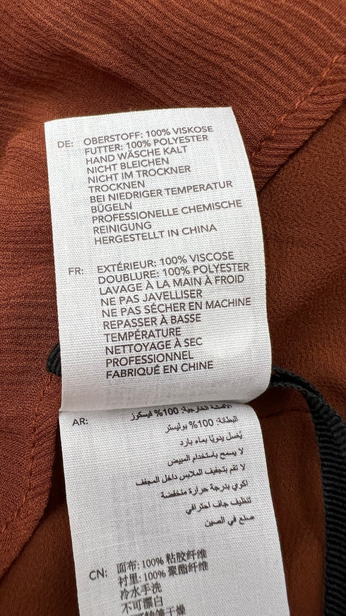 Blusa con fiocco e cartellino
