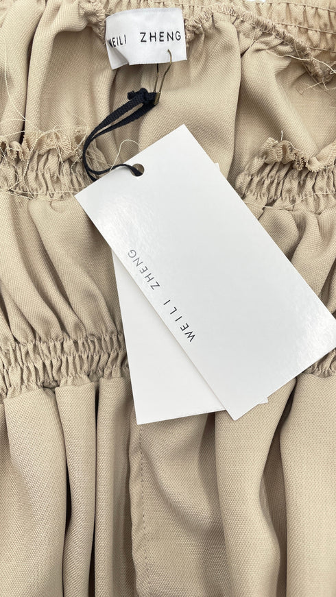 Blusa arricciata con cartellino