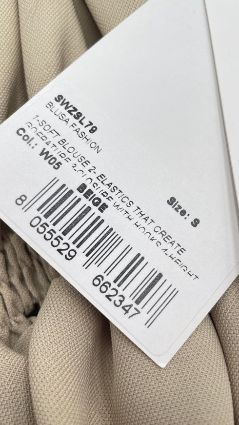 Blusa arricciata con cartellino