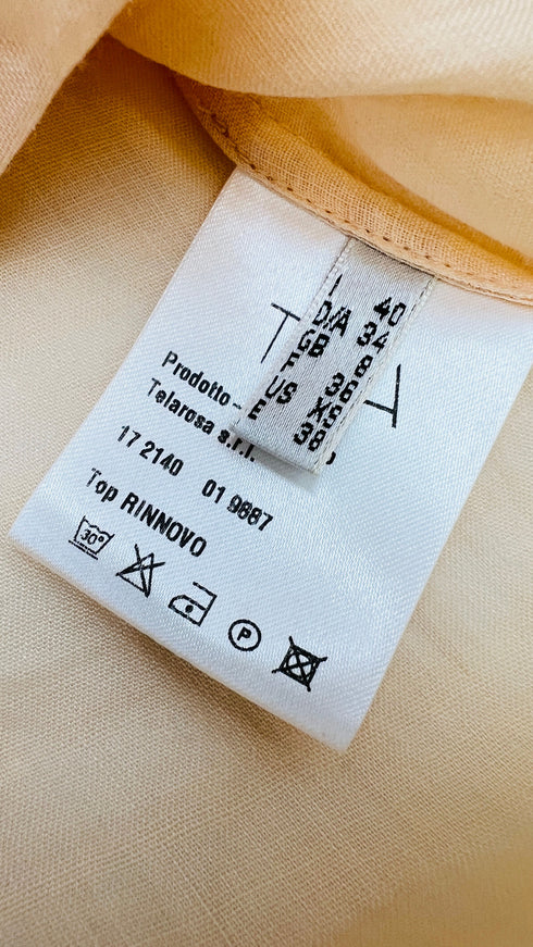 Top smanicato con volant