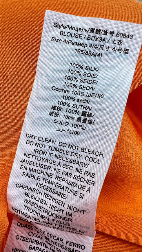 Blusa in seta con cartellino