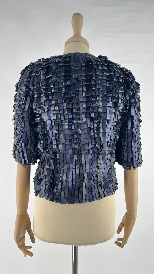 Bolero in pelle con cartellino
