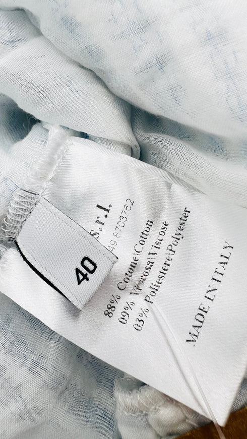 Top smanicato collo frange