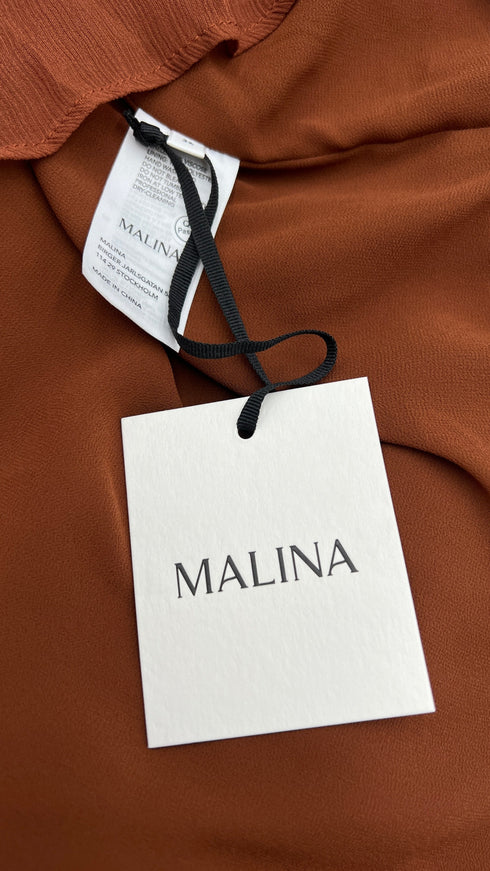 Blusa con fiocco e cartellino