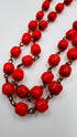 Collana lunga in perle rosse e metallo brunito
